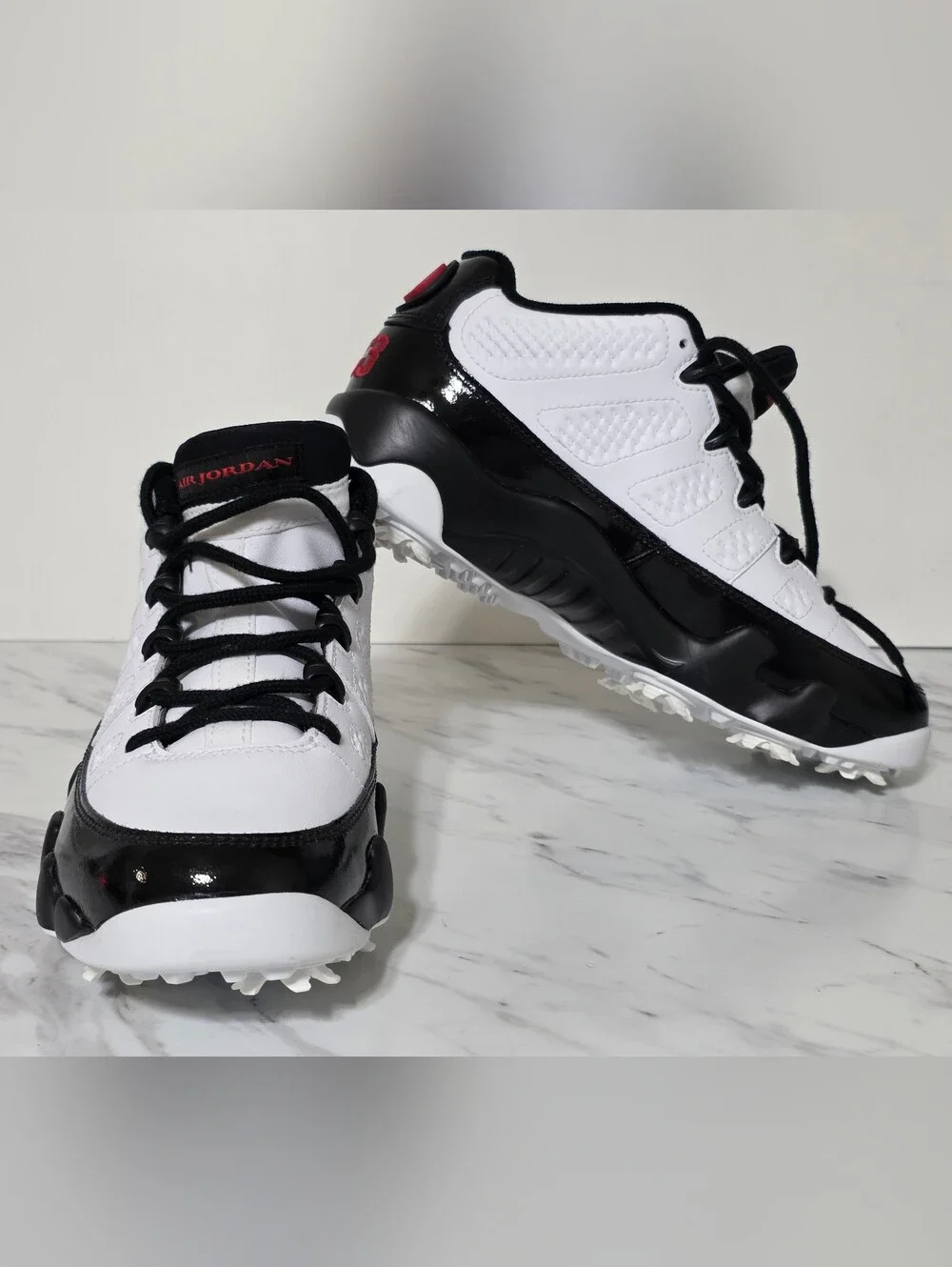 Jordan White and Black Golf Cleats with Red Logo